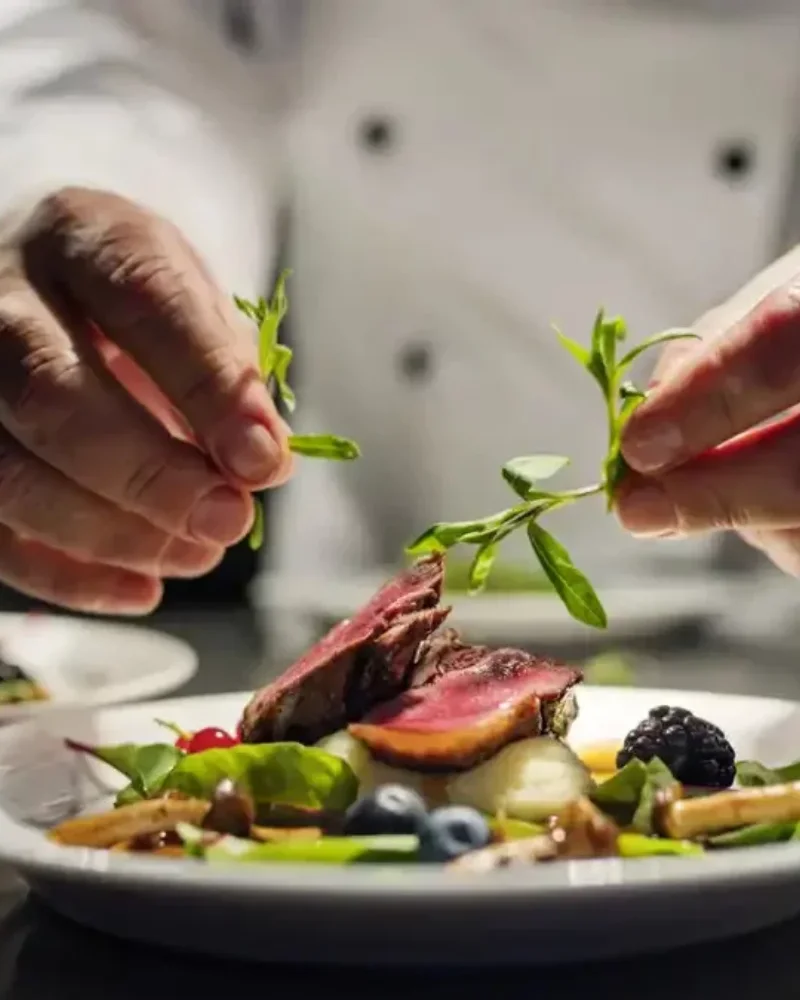 Private chef plating a fine-dining course